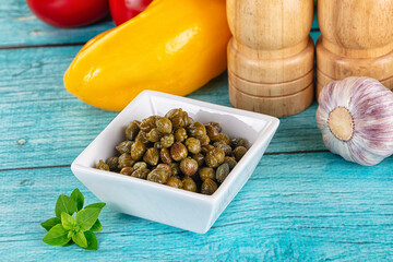Pickled canned capers in the bowl