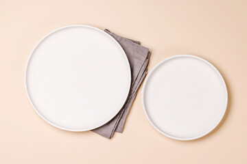 Empty plate on beige background, food mockup with natural light