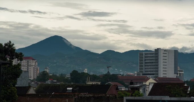 Timelapse of clouds calmly rolling over the mountain in the afternoon