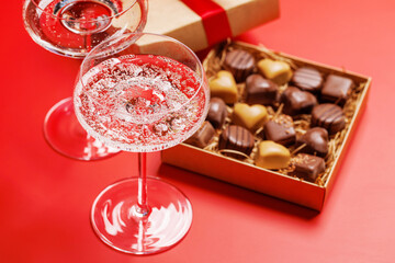 A glasses of champagne elegantly paired with a gift box