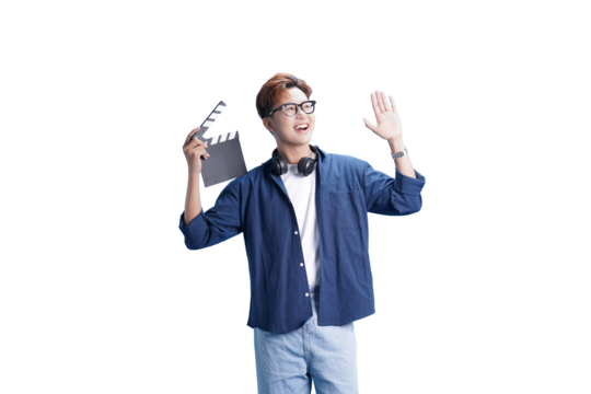 Action in Frame: An Asian man, smiles and waves while holding a clapperboard, he wears glasses and casual clothes. Ready to action.