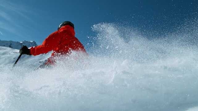 Skier riding in the scenic Dolomites mountains in fresh powder snow. Super slow motion at 1000 fps.