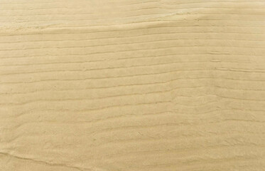 Minimal Close-Up of Smooth Beach Sand with Natural Horizontal Ripple Patterns and Soft Shoreline Texture