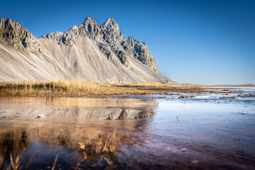 Vestrahorn rises 454 meters from the black sand coast, a basalt and gabbro formation shaped by glacial and marine erosion in Iceland&rsquo;s southeast.