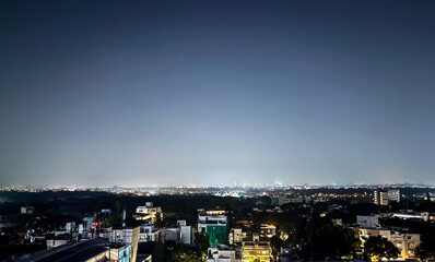 Night City Skyline with Illuminated Buildings Under Clear Sky