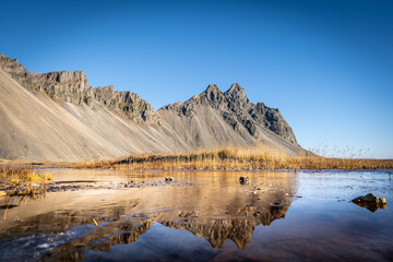 Vestrahorn rises 454 meters from the black sand coast, a basalt and gabbro formation shaped by glacial and marine erosion in Iceland&rsquo;s southeast.