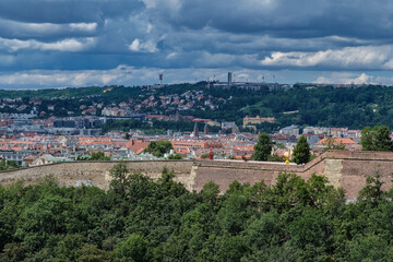 Fototapeta premium Breathtaking panoramic view of Prague, showcasing its historic city center with iconic buildings, charming red-roofed houses.