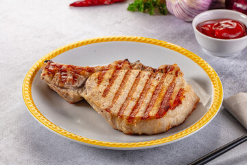 Tasty hot grilled bone steak served sauce