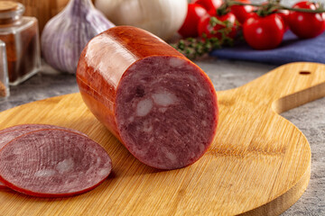 Ham sausage with slice over board