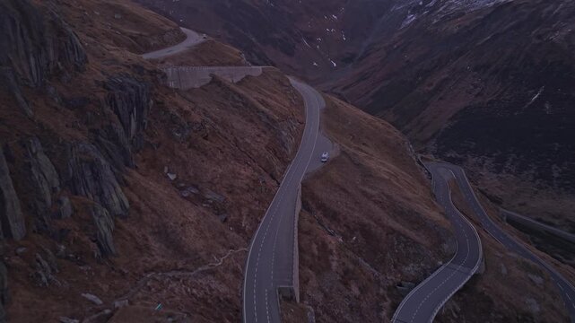 Sunrise over Furka Pass, a winding road through the Swiss Alps.
