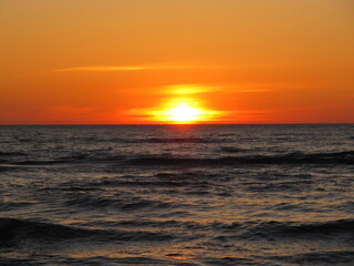 Fiery Sunset Reflected on Vibrant Ocean Waves