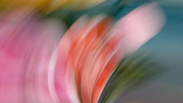 Dynamic motion blur abstract background with streaks of vibrant pink, orange, and teal green color