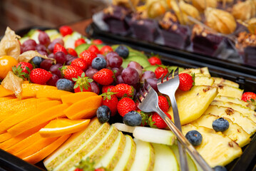 Colorful fresh fruit display for events. A vibrant assortment of fresh fruits including strawberries, blueberries, grapes, and pineapple.
