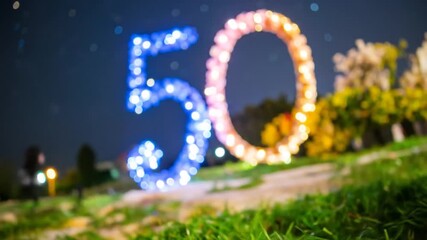Sparkling 50th Birthday Celebration: Illuminated Number Display at Night