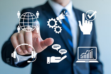 Businessman interacts with digital icons representing global communication marketing automation customer service and data analytics showcasing modern business solutions and technology integration