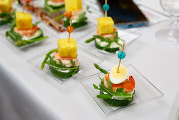 Gourmet appetizers with shrimp and egg. Elegant gourmet appetizers featuring shrimp, boiled egg, and pineapple adorned with colorful toothpicks. 