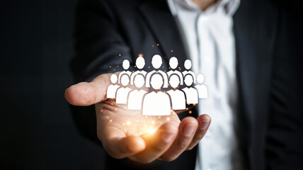 Businessman presents team or community concept with glowing figures in his hand symbolizing leadership collaboration and human resources management in a modern business environment