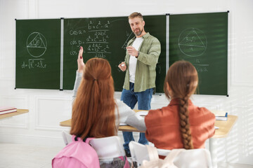 Teacher and students during lesson in classroom