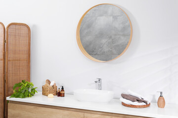 Stylish bathroom interior with mirror, folding screen and vessel sink