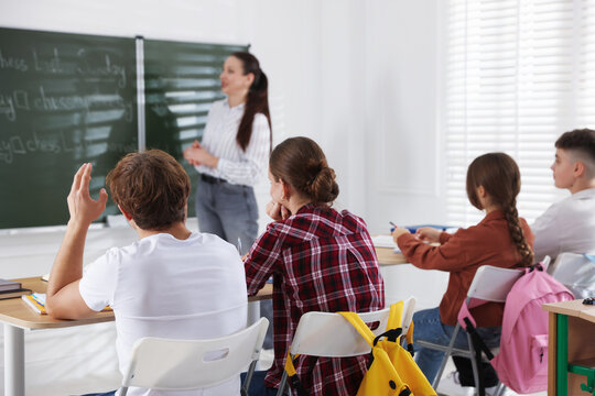 Teacher and students during lesson in classroom, selective focus