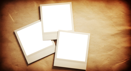 Three blank, white instant photo frames, styled like Polaroids, are scattered randomly on a background of crumpled, aged, and textured brown paper. The paper has dark, vignetted edges.