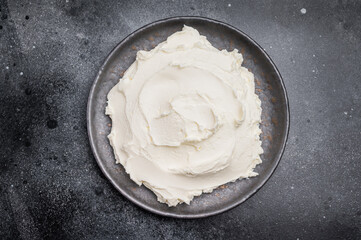 Creamy Homemade Mascarpone cheese, cream cheese. black background. top view