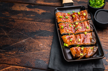 Japanese grilled eel with sweet soy sauce . wooden background. top view