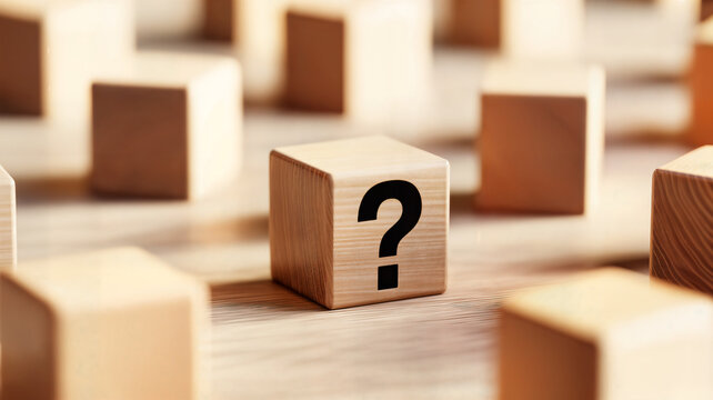 Wooden blocks with a question mark symbolize uncertainty and problemsolving ideal for illustrating concepts like questions answers solutions and decisionmaking in various contexts including education 