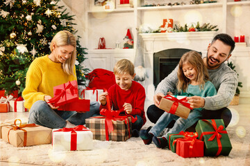 Happy New Year 2026 greeting card, bokeh lights. Family with Christmas gifts at home