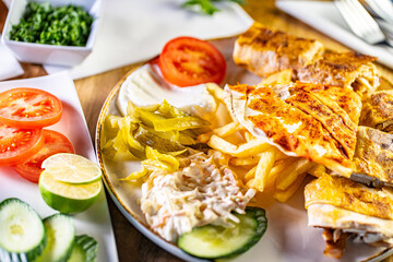Chicken roll breast stuffed with butter, garlic and dill. Served with baked potato slices and fresh herbs.