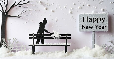 Silhouette clearing snow from park bench. Winter scene, festive greeting visible. Snowflakes falling, simple design.
