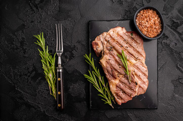 Grilled pork neck steaks. black background. top view