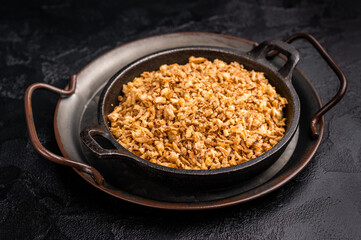 Crispy Fried dried Onion Bits. black background. top view