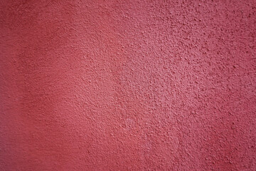 Textured grunge red wall with a rough surface outdoors