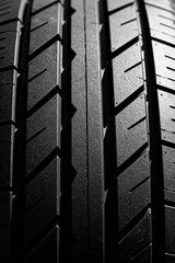 Close up view of a new tire showcasing tread pattern and design at an automotive service center