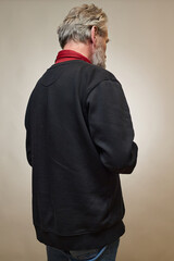 Old man over 60 portrait in studio with smartphone