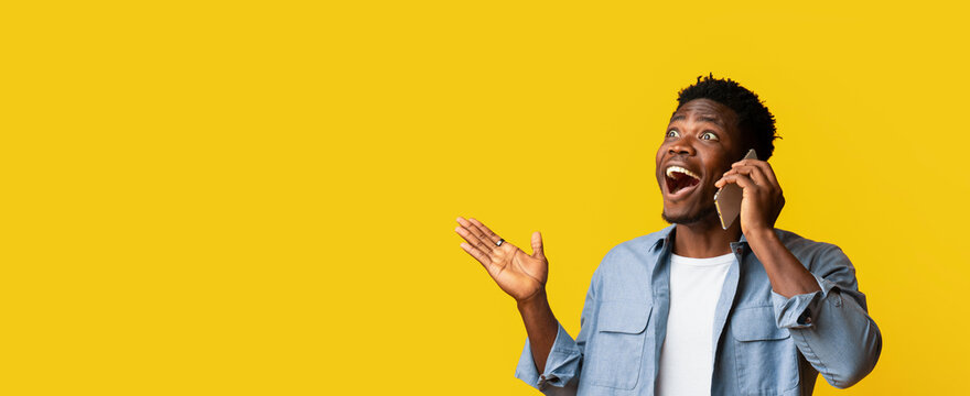 A man expresses joy while talking on his phone with a vibrant yellow background.