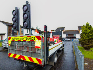 Highway Maintenance vehicle parked in a residential area, for road work operations. Equipped,...