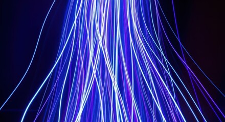 Abstract streaks of blue and white light trails on a dark background