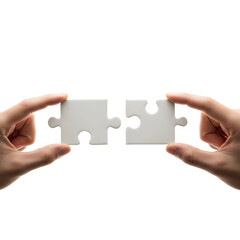 Hands holding two white jigsaw puzzle pieces connecting them symbolizing teamwork and problem-solving on a white background