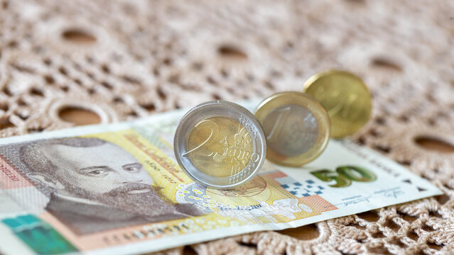 Eurozone Bulgaria, Financial and economic concept. Euro coins and a 50 Bulgarian lev note lying on a tablecloth.
