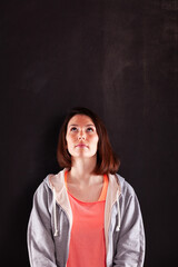 Young casual Woman next to a blackboard
