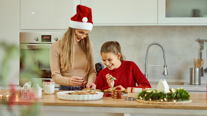 Mom And Daughter Making Christmas Gingerbread Cookies In A Cozy Kitchen Together. Banner, copy space