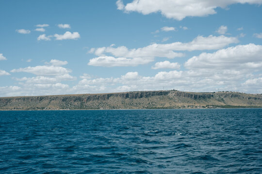 Scenic view of sevan lake and mountain plateau under a cloudy sky