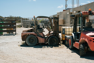 Rustic construction site with old forklifts under sunny skies