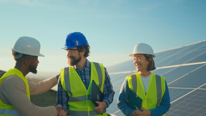 Team celebrates successful solar project completion at a renewable energy site in broad daylight