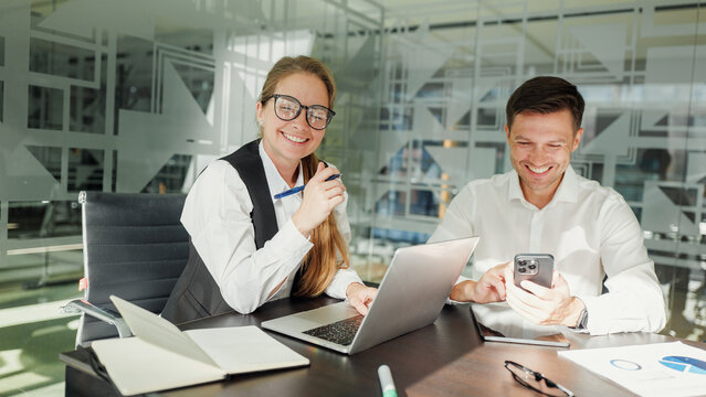 Team members collaborating in a modern office space - Powered by Adobe
