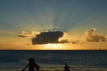 Fototapeta premium Sun hidden behind cloud at beach
