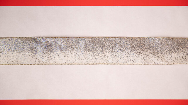 Sparkle, glitter, gold and silver ribbon with white and red background for a festive holiday or event template