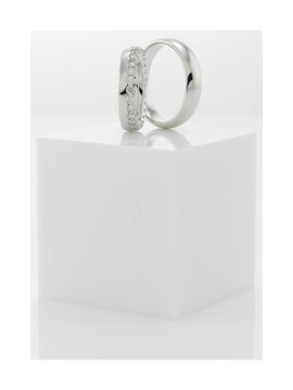 Still life of wedding rings on a white pedestal